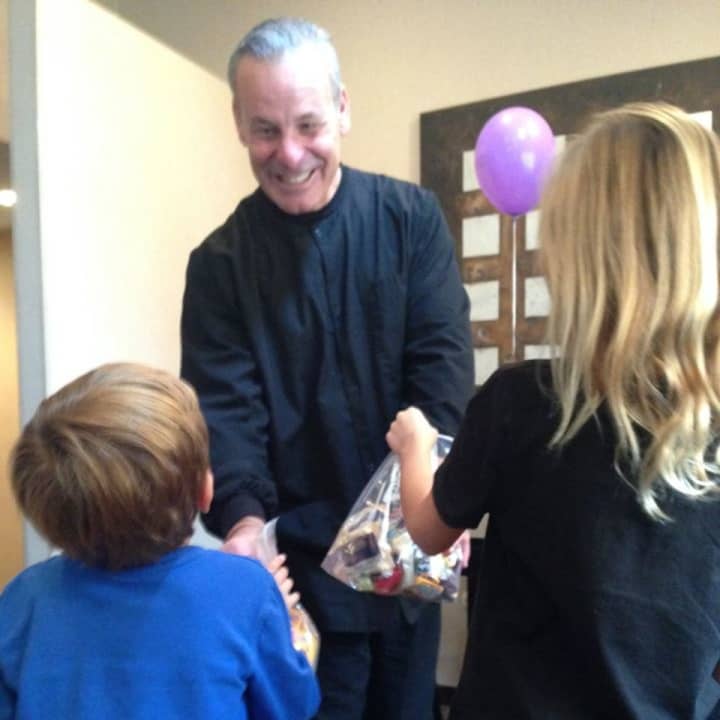 Children donate their leftover Halloween candy to Dr. Archer Katz.