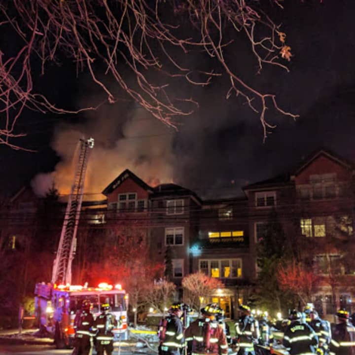 Fire crews battle a raging blaze at a condo complex at 100 Richards Ave. in Norwalk early Monday evening.