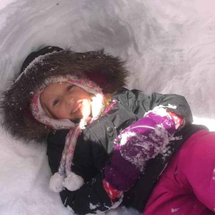 Sophia, 5, hangs out in a snow fort.