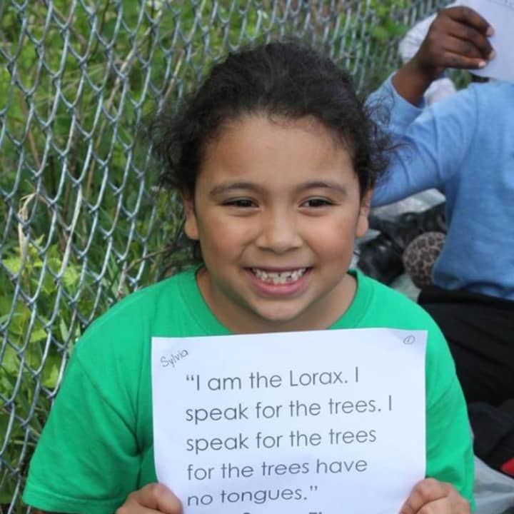 A student from Woodside Elementary School in Peekskill holds up a line from &quot;The Lorax.&quot;