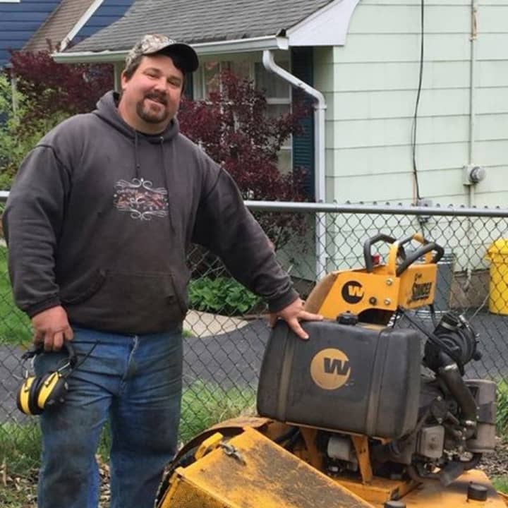 A local landscaper pauses from a job to chat with Daily Voice.