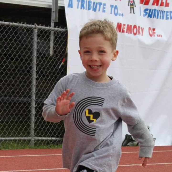 Cooper Palatnek, 5, takes a victory lap around the track at Pascack Valley High School.