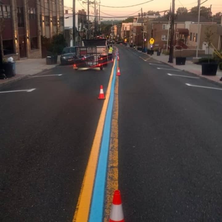 Carlstadt DPW workers painting the thin blue line on Hackensack Avenue.