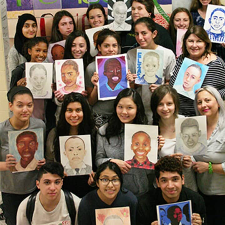 Harrison High School students show off their artwork for kids in Tanzania.