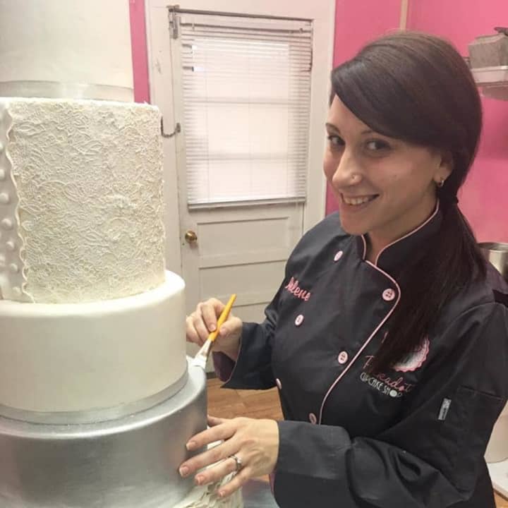 Arlene Murray of Lyndhurst puts the finishing touches on a wedding cake.