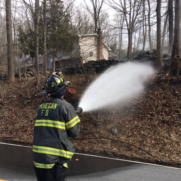 Firefighters from the Mohegan Volunteer Fire Department battled a fast-moving brush fire in Cortlandt Manor on Thursday.