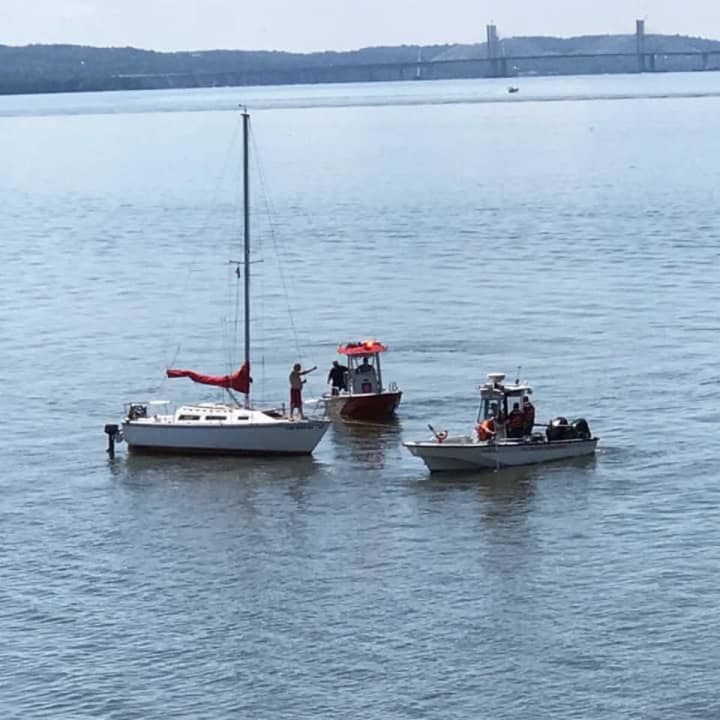 Crews from the Croton-on-Hudson Fire Department aiding a sailboat that got stuck on a sandbar in the south end of Croton Point.