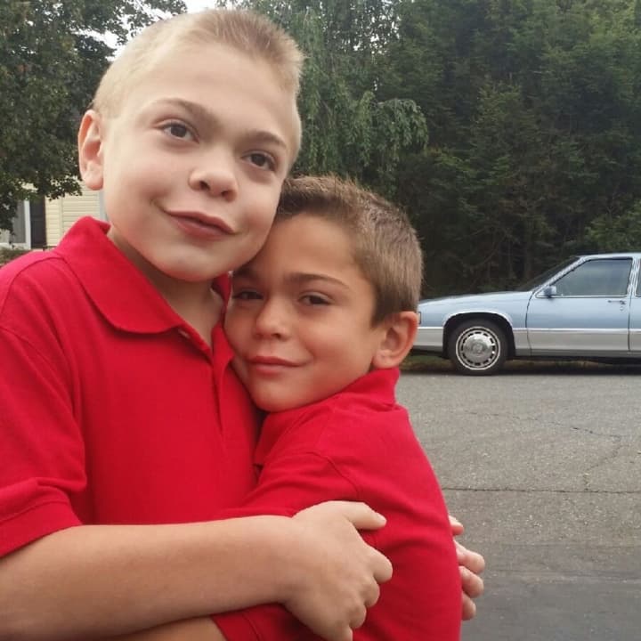 Jason, left, and Justin Leider hug. Their dad founded Let Them Be Little X2 Foundation after they were diagnosed with Hunter syndrome.