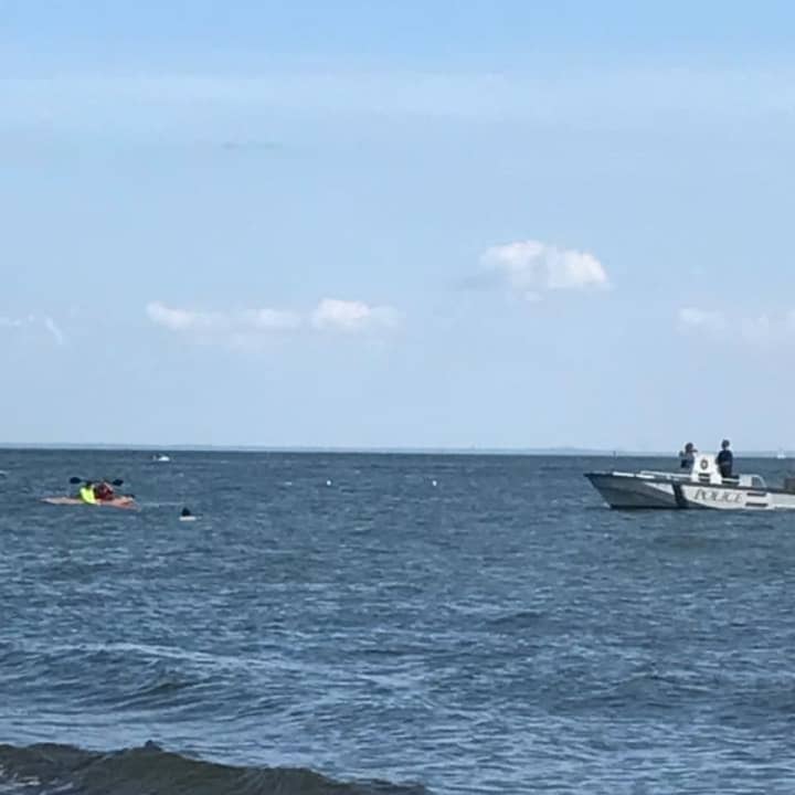 Westport Marine police come to the aid of a capsized kayaker off South Beach at Compo on Sunday.