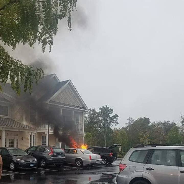 A car is fully on fire Sunday morning at at the Rivington &quot;The Mews&quot; complex in Danbury.
