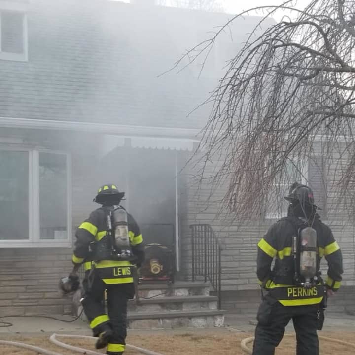 <p>Danbury firefighters extinguish a blaze in a kitchen and clear smoke from a home on Sixth Street.</p>