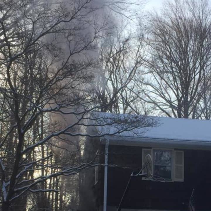 A fire at a home at 70 Osborne Lane in Monroe was contained to the garage on Saturday morning, firefighters said.