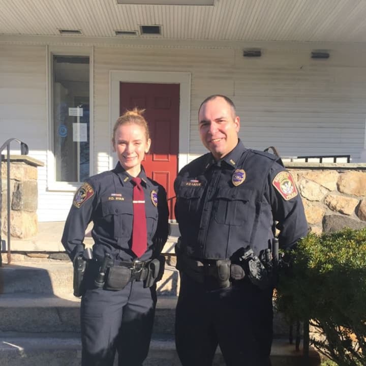 Officer Victoria Ryan (L) and Officer Jeffrey Ladue (R) show off the new blue uniforms that the Ridgefield Police Department will be wearing in 2018.