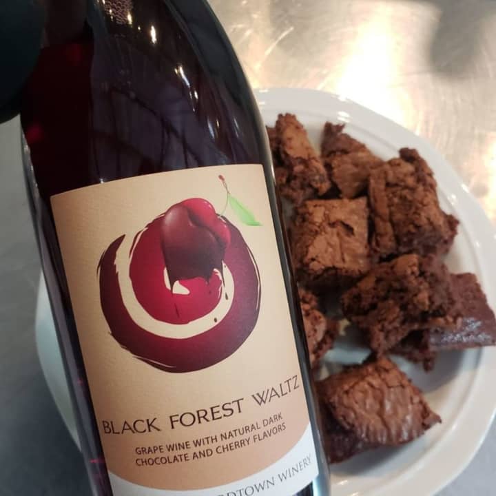 Port of Leonardtown Winery&#x27;s Black Forest Waltz chocolate wine with a plate full of chocolate brownies – it&#x27;s ideal pairing.
