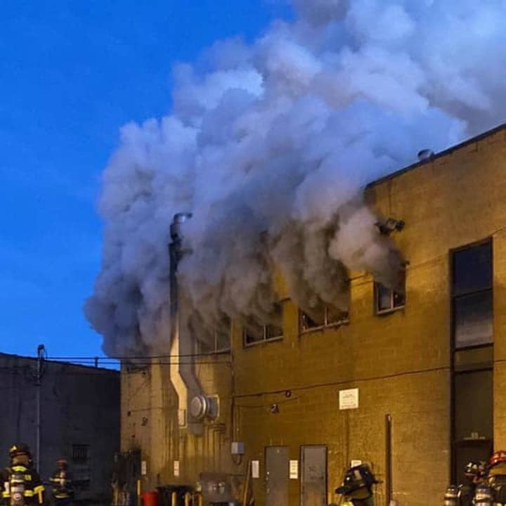 Suffern firefighters are battling a four-alarm fire at a two-story commercial structure.