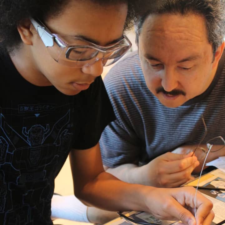 Jonathan Ayala with his dad at last year’s Innovation Day learning how to solder at the Wilton Library.