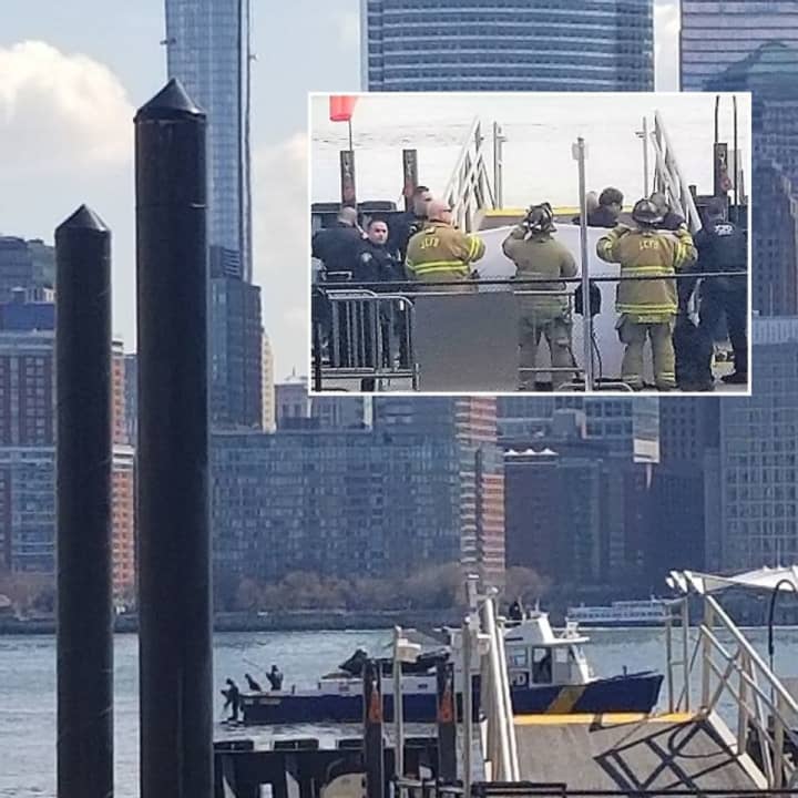 Witnesses gathered along the Hudson River in Jersey City as the body, which was bagged on the boat, was brought to shore around 12:30 p.m.