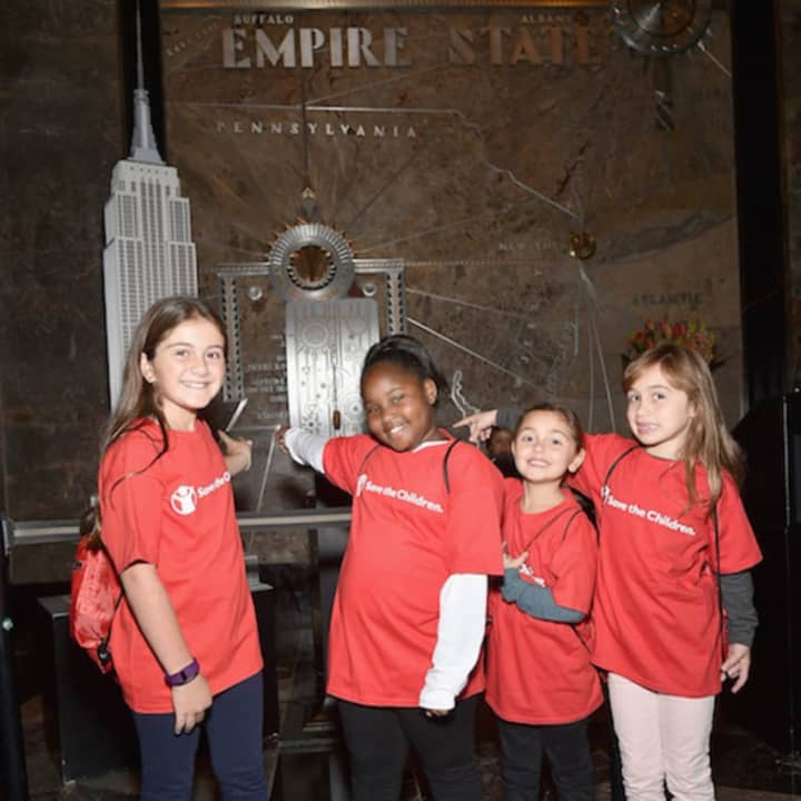 From left: Kate Papadatos of Norwalk, Miracle Jones of Blackville, S.C., Colette Prainito of Farmingville, N.Y., and Antonella Garcia of Basking Ridge, N.J., help to light up the Empire State Building.