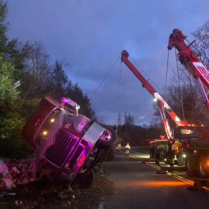 A tractor-trailer carrying eggs ran off the road and overturned.