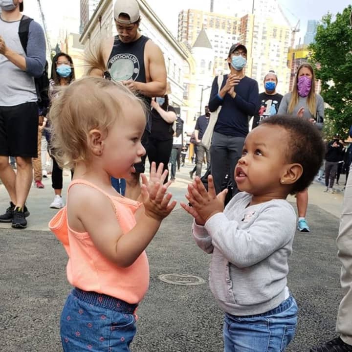 Friends Cleo, left, and Aubree play during a peaceful protest in Jersey City.