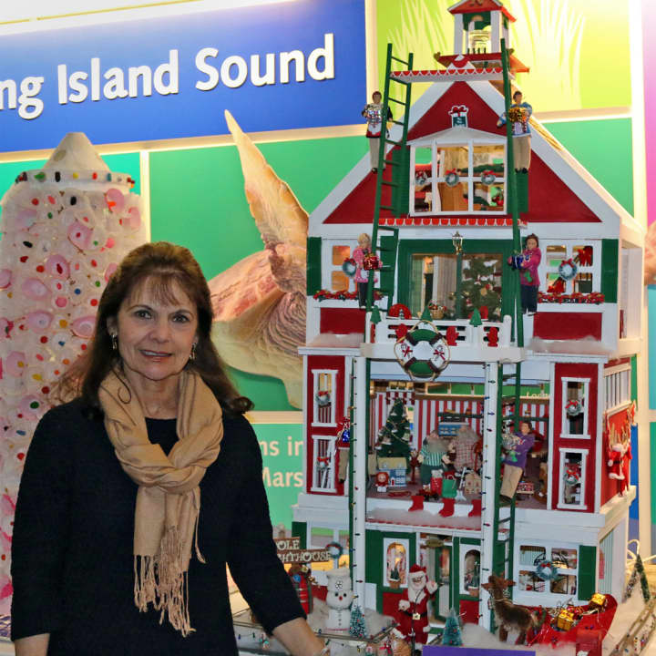 Jo Stecker, of Norwalk, with her fifth-place winner, “North Pole Lighthouse,” in The Maritime Aquarium at Norwalk’s 14th annual “Festival of Lighthouses Contest.”