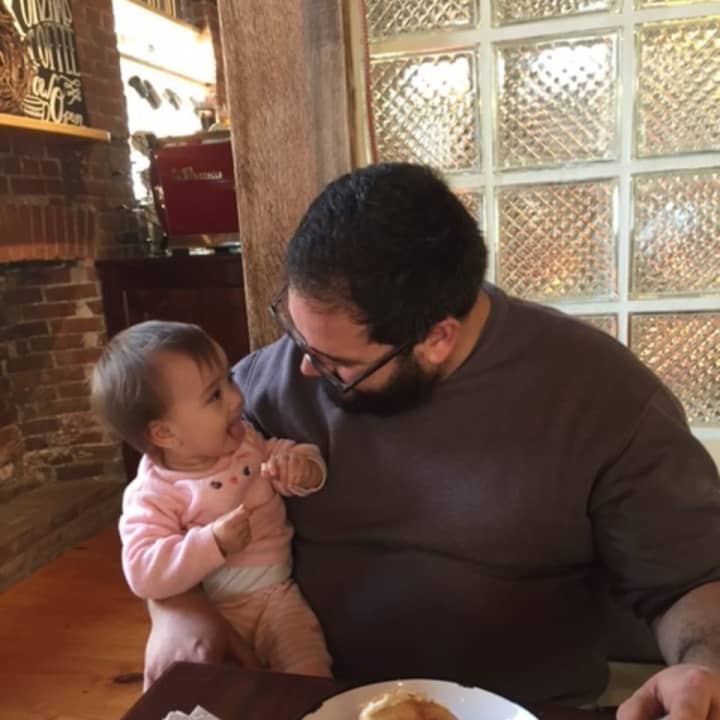 Gabriel Arango Jr. and his baby daughter, Nora, enjoy bagels and cream cheese at his new cafe, Kurzhal&#x27;s Coffee, on Peekskill&#x27;s Main Street.