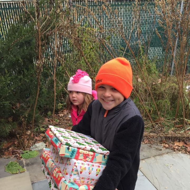 Children with the Families for Astor Committee helped deliver gifts for children of Astor and their families as part of Astor&#x27;s 2016 Adopt-A-Family program.
