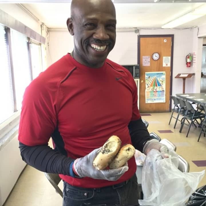 Anthony Austin, a retired New York City firefighter and volunteer at the Salvation Army community center in Peekskill, bags up bagels.
