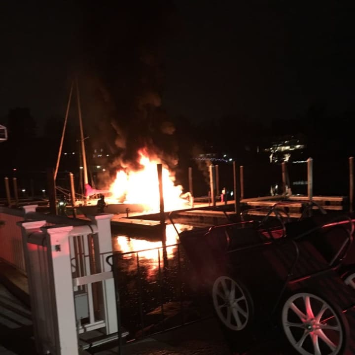 A boat is consumed by flames late Friday at the Greenwich Boat and Yacht Club on Grass Island Road in Greenwich.
