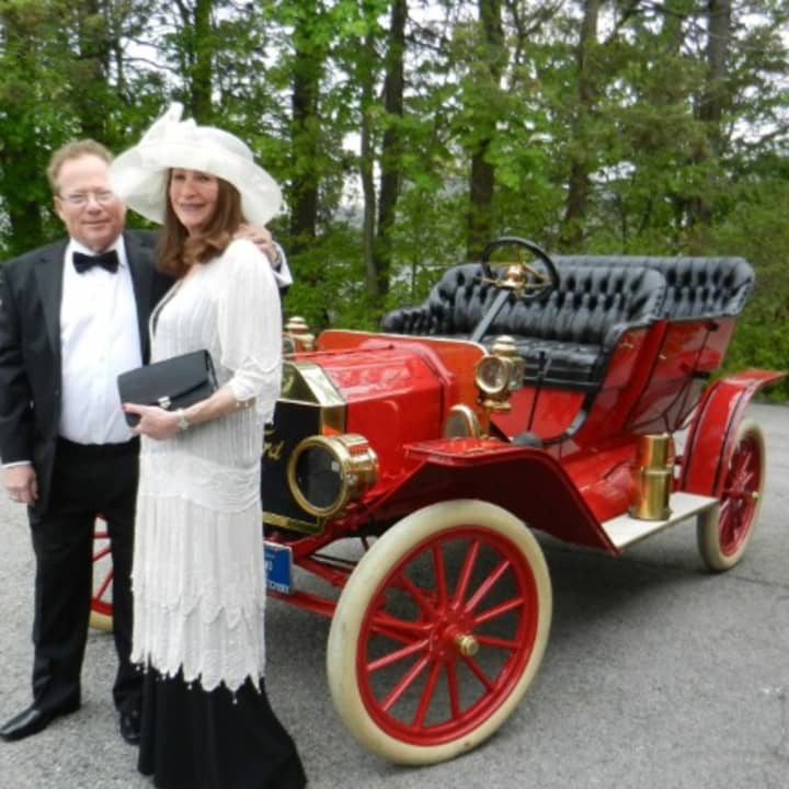 White Plains Historical Society Trustee Howard and Lea Waldman, stand in front of an old Ford during the White Plains Historical Society Centennial Ball.