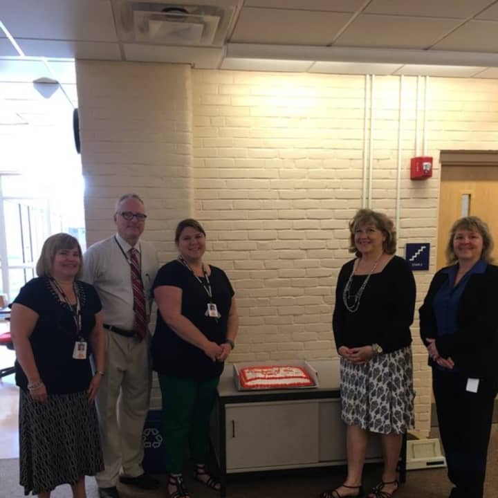 Melissa Fenstermaker, third from left, stands with a cake honoring her selection as the Shelton School District&#x27;s Teacher of the Year.