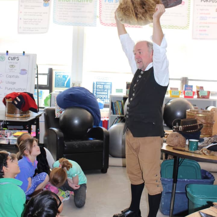 Sam Ladley (aka “Colonial Man&quot;), dressed in colonial garb, presented a quick-paced lecture using dozens of artifacts to demonstrate his instruction, choosing from tables full of period tools, clothing, animal skins and weapons.