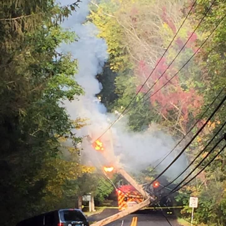 The pole and wires are burning after an accident on Zaccheus Mead Lane at Fox Run Lane in Greenwich on Sunday morning.