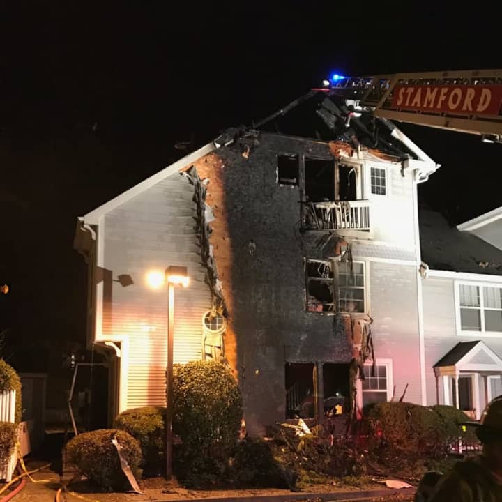 A three-alarm fire heavily damages a condo at 1 Southfield Ave. in Stamford on Wednesday evening.