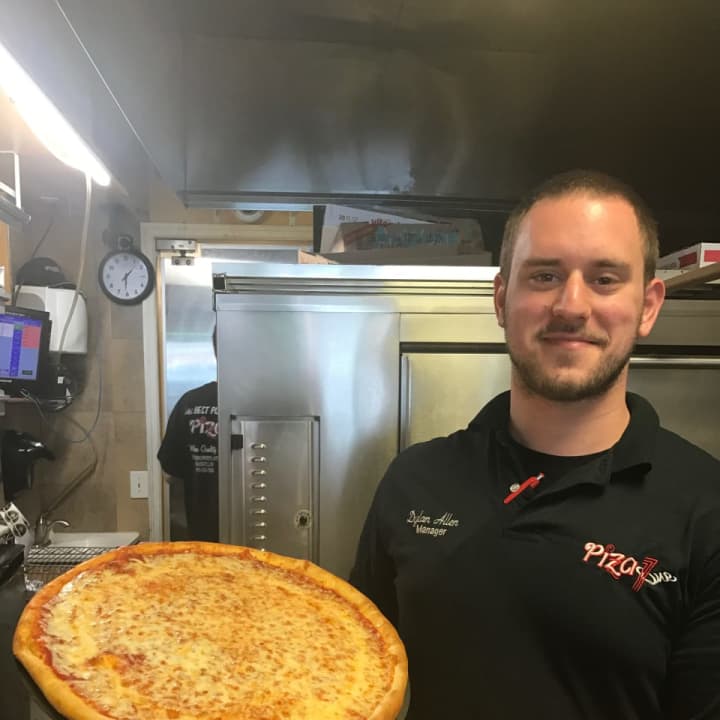 Dylan Allen, the manager at Pizza One in Wayne, shows off a perfectly cooked pie.