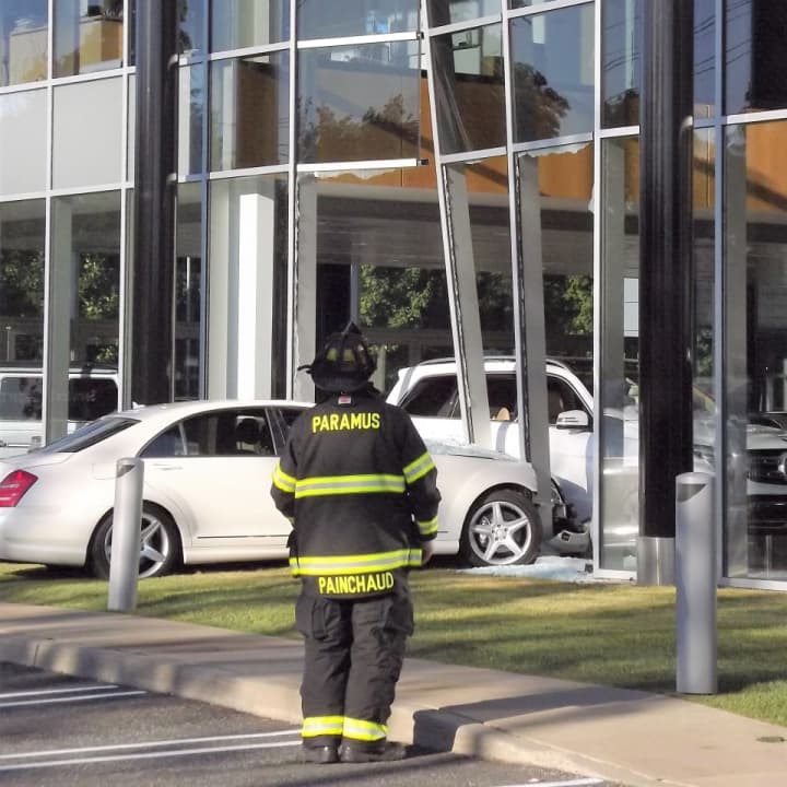 The window about 40 to 50 feet up shattered when the sedan slammed into an aluminum pillar at Prestige Motors.