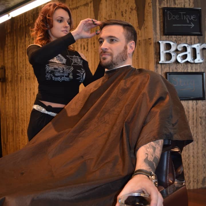 Christine Modica cuts Jordan G&#x27;s hair as he sips whiskey at Stag House in Glen Rock.