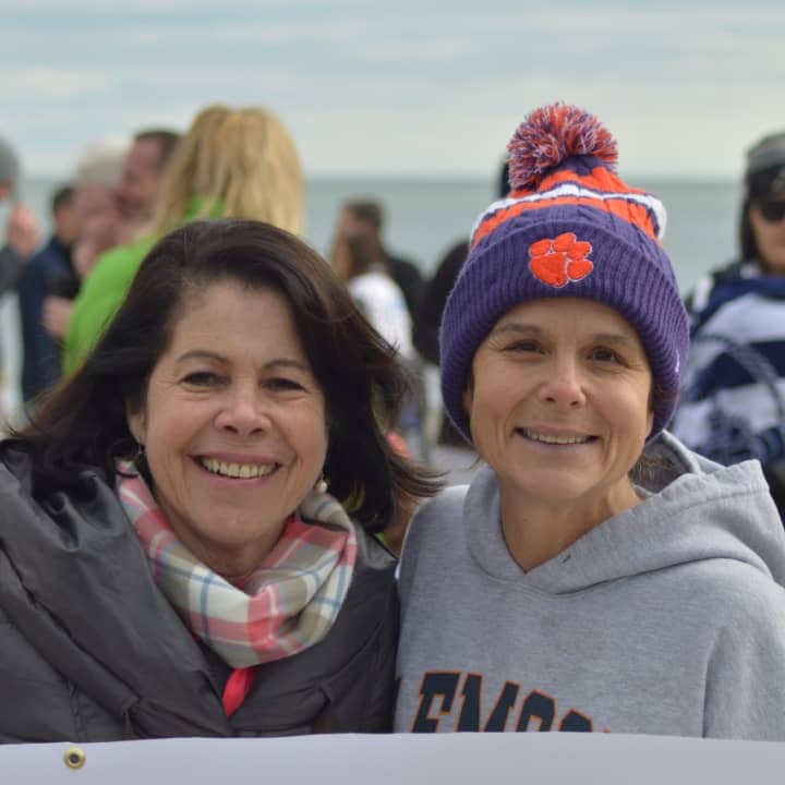Angela Swift (right) has been a regular participant in the Old Greenwich on New Year&#x27;s Day Dip at Tod&#x27;s Point for many years. She also came up with the idea of selling T-shirts to benefit Kids in Crisis.