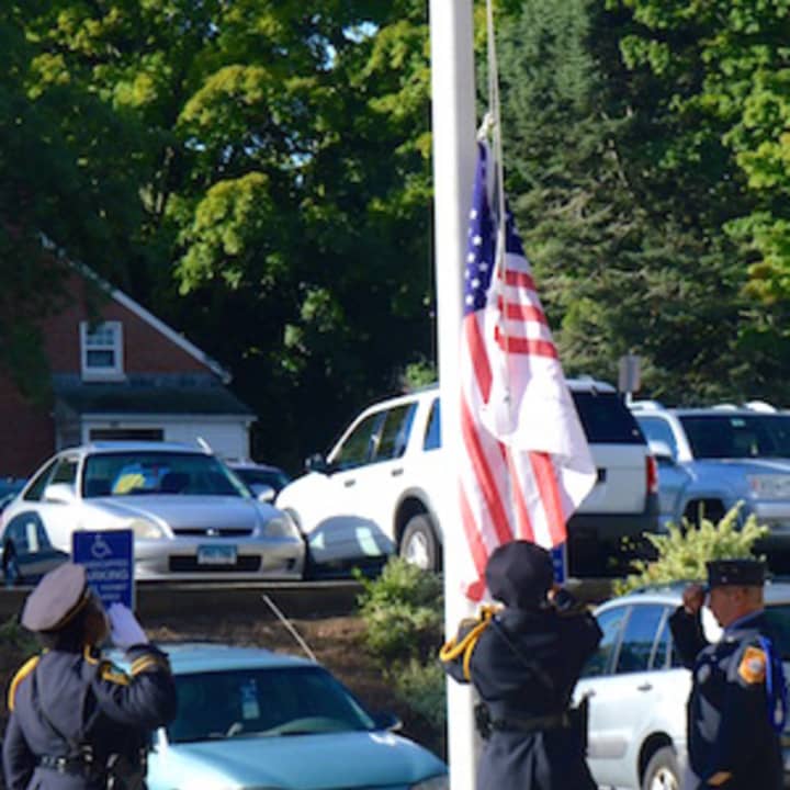 Members of the Norwalk Fire Department/Police Department Joint Honor Guard salute the flag at the posting of the colors during Norwalk&#x27;s Sept. 11 remembrance ceremony.