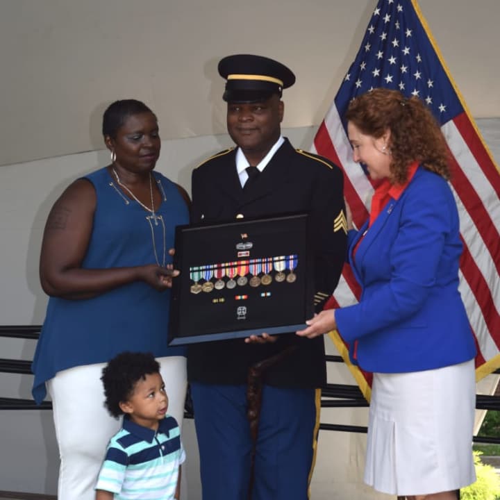 Robert Carpenter, with his wife and grandson, is presented with his military medials by U.S. Rep. Elizabeth Esty.