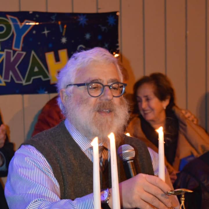 Rabbi Yehoshua Hecht lights the menorah at Stew Leonard&#x27;s in Norwalk Monday.
