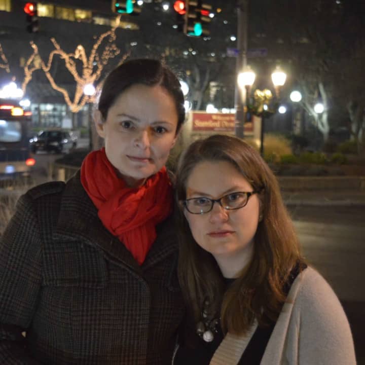 Wendy Skratt and a fellow member of the ENOUGH Campaign gather at a vigil for gun violence Thursday evening in Stamford. 