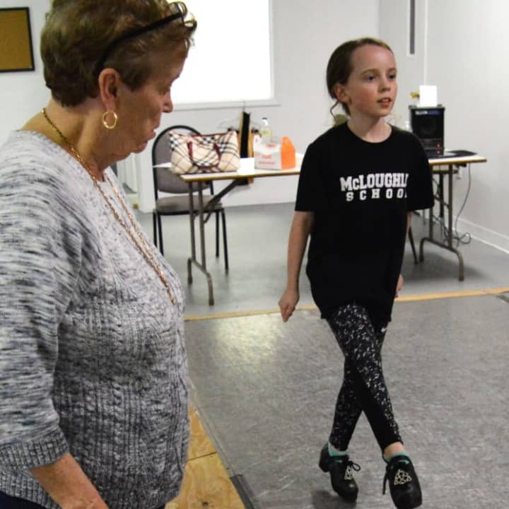 Patsy Early McLoughlin, one of the directors of the McLoughlin School of Irish Dance, observes the form of Evelyn McGowan of Glen Rock.