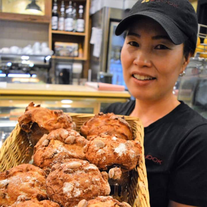 Keum Sook Park with her orange peel brioche made with candied orange peel, almond cream, and almonds.