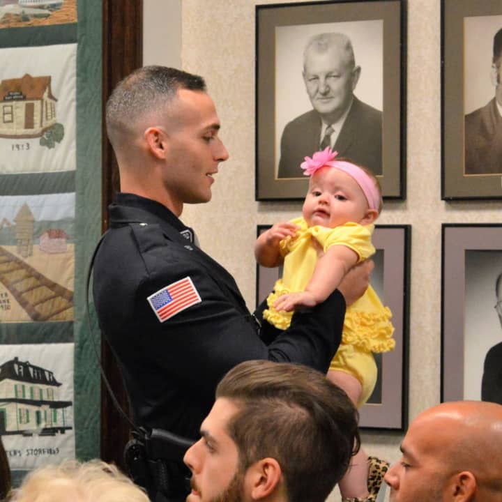 As he awaits his swearing in ceremony, Corey Rooney shares a moment with his niece.