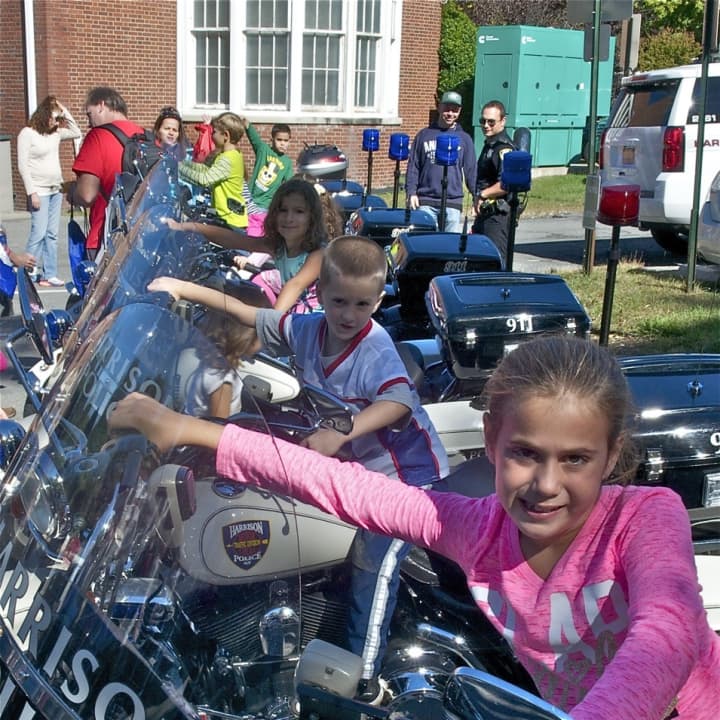 Kids get a chance to sit on police motorcycles at Sunday&#x27;s Open House. 