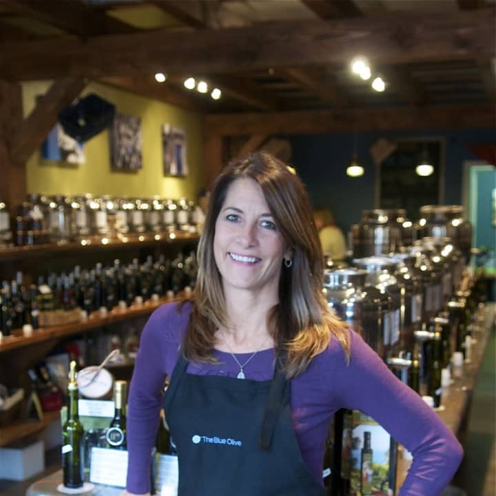 Blue Olive co-owner Beth Canevari with her olive oil and vinegar products.