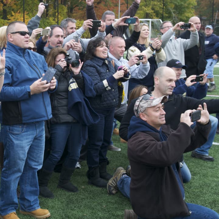 Our Lady of Lourdes High School football parents cheer the team on earlier this season. The school won the Section 1 Class A title on Saturday.
