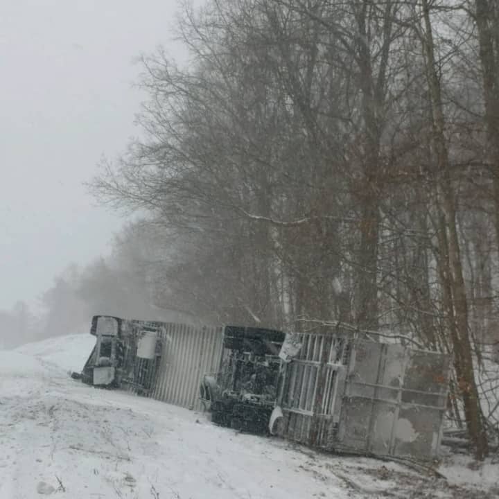 The tractor-trailer overturned after crashing down the embankment on I-84 in Fishkill.