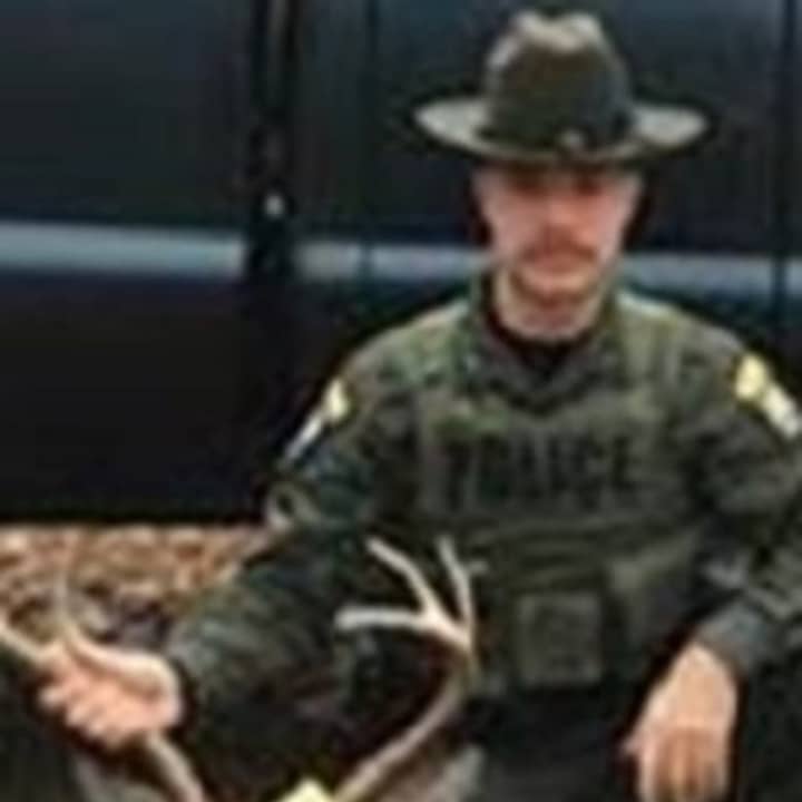State Environmental Control Officer Anthony Drahms with a buck that the DEC says was illegally taken in Putnam County. The hunter, who was charged with violating state law, told the officer that he did it for his kid, the DEC says.